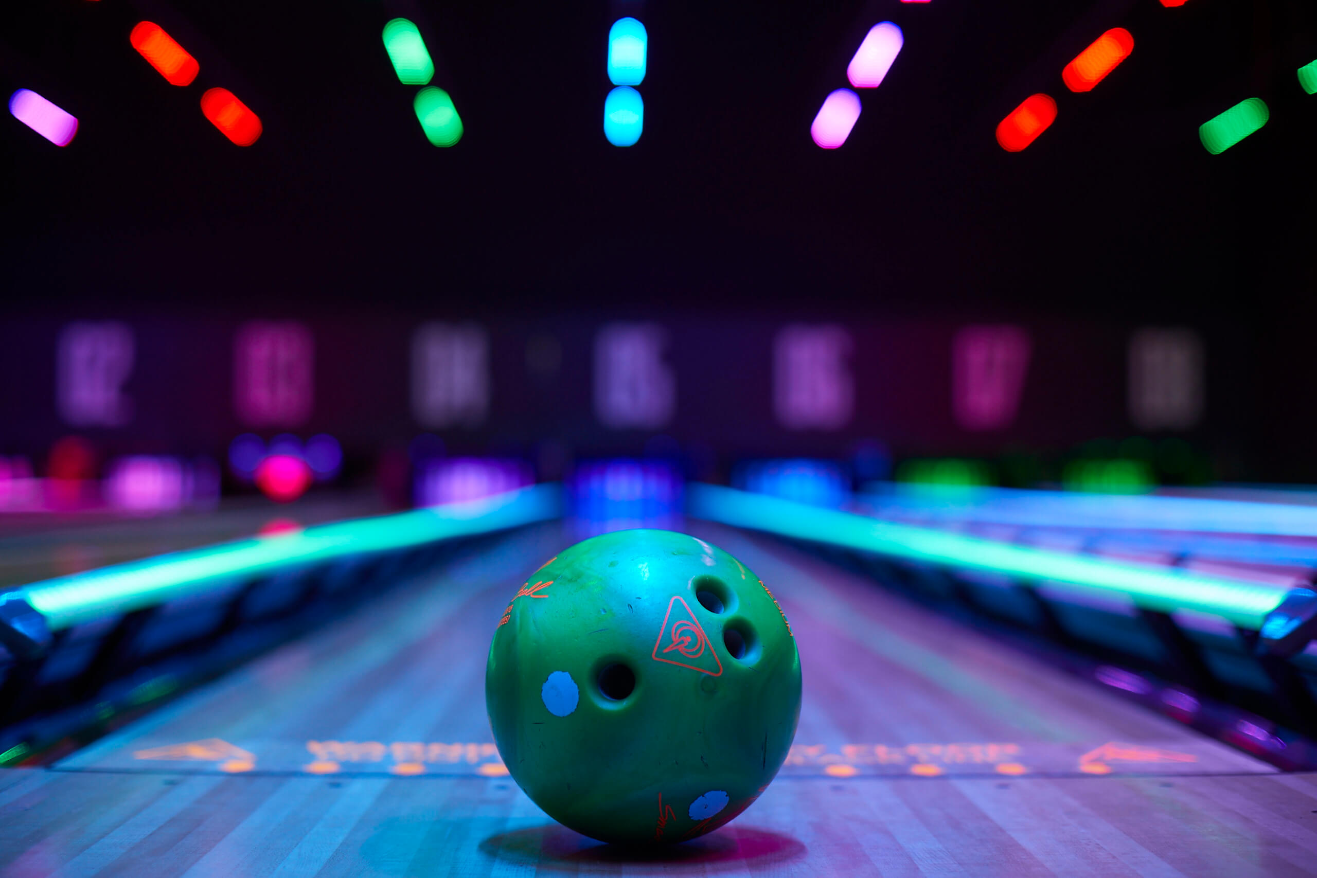 Green Bowling Ball In Front Of Bowling Lanes