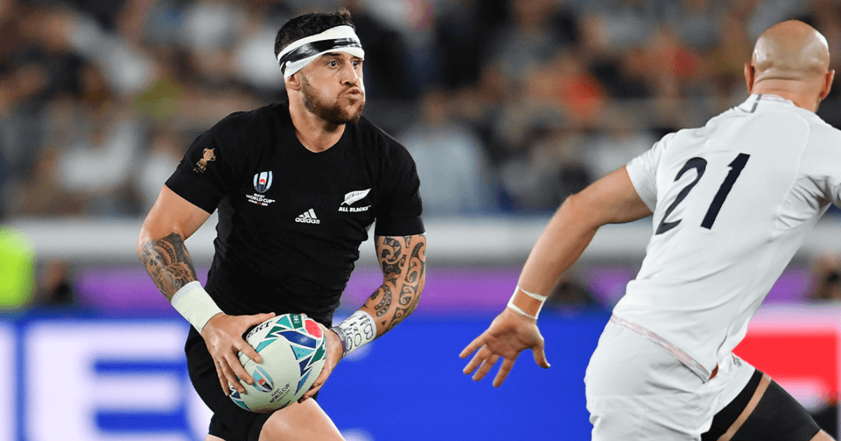 Player From The All Blacks Running Towards Opponent With Ball (1)