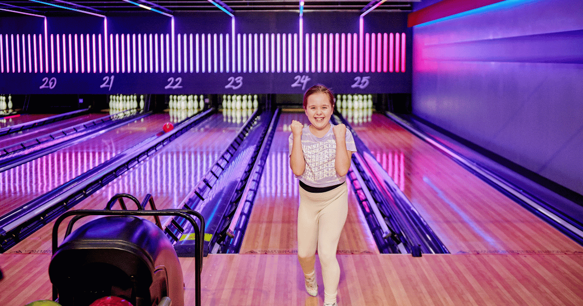 Young Girl Celebrates At She Scores A Strike At Tenpin (1)