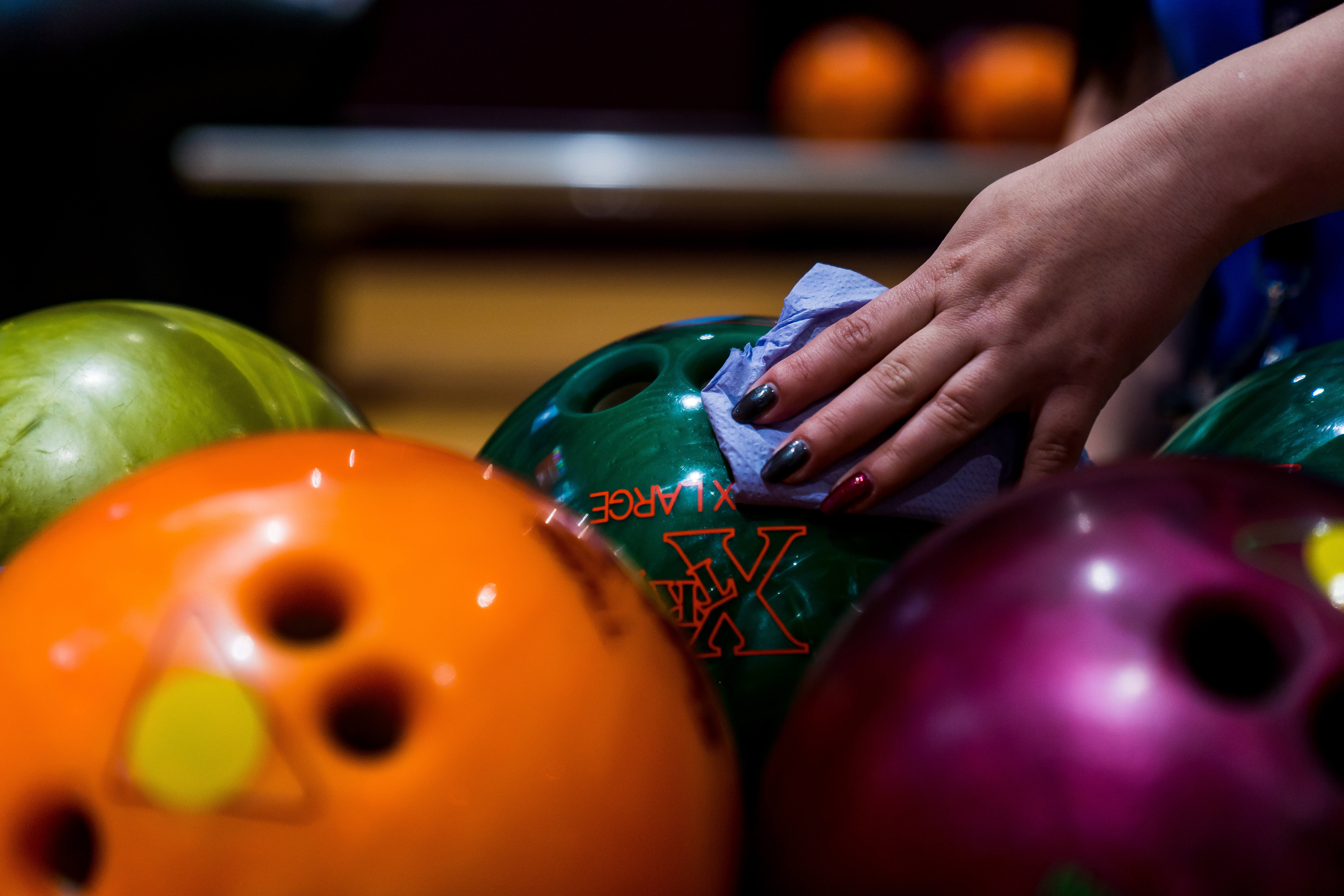 Bowling Balls Being Wiped Cleaned