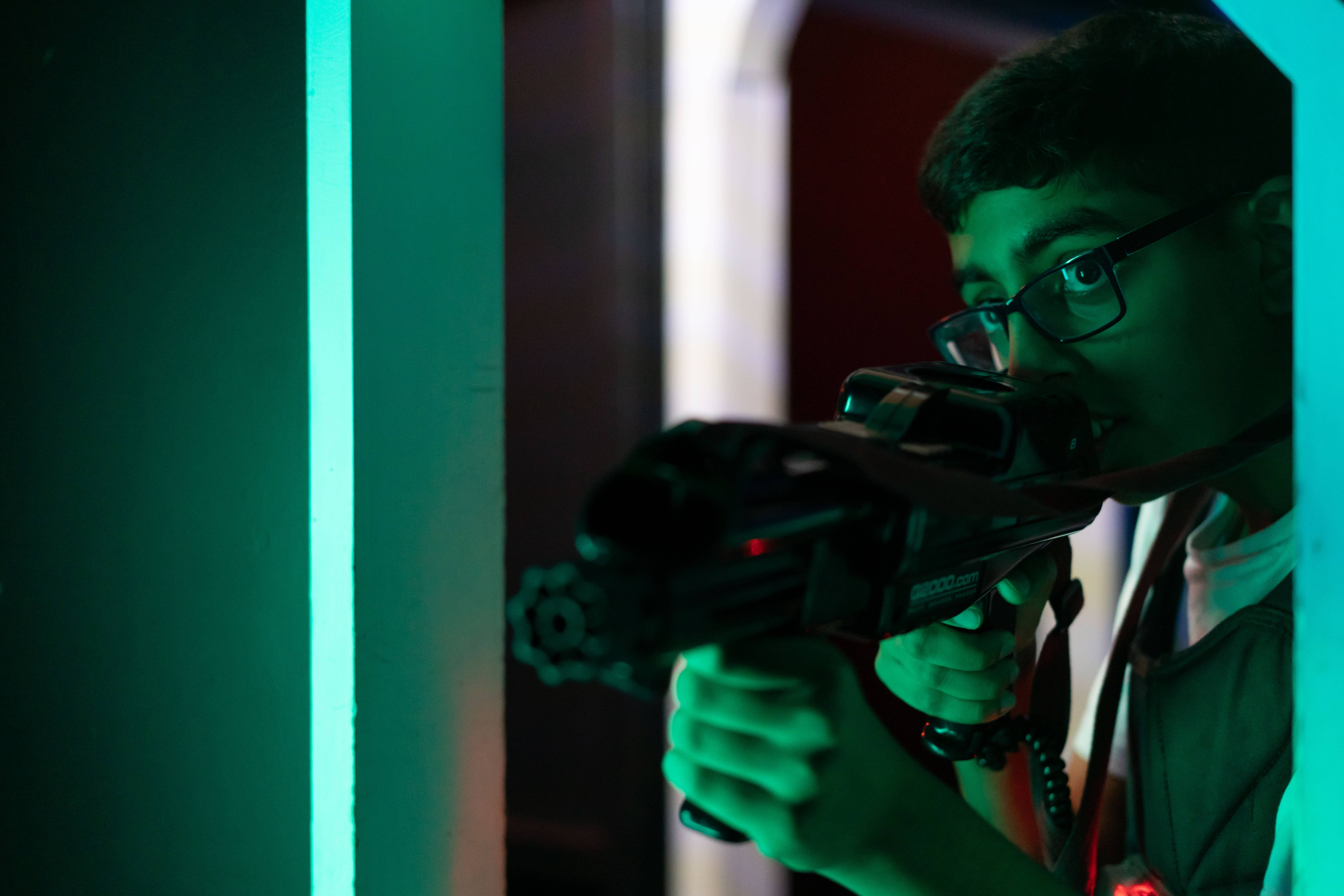 Boy Hunting Enemy In Laser Tag Arena