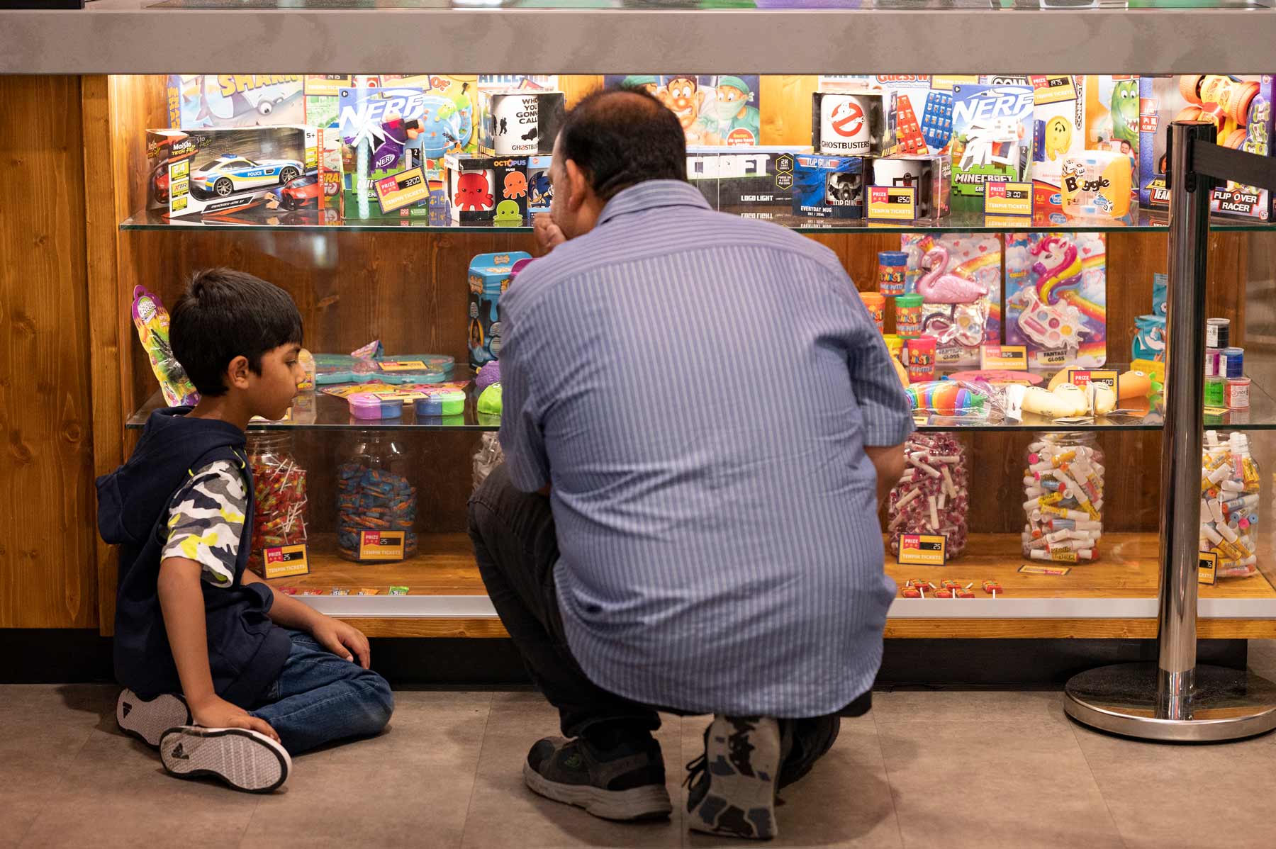Little Boy Choosing His Prize In The Arcade