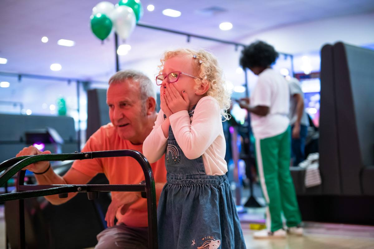 Little Girl Bowling With Grandad