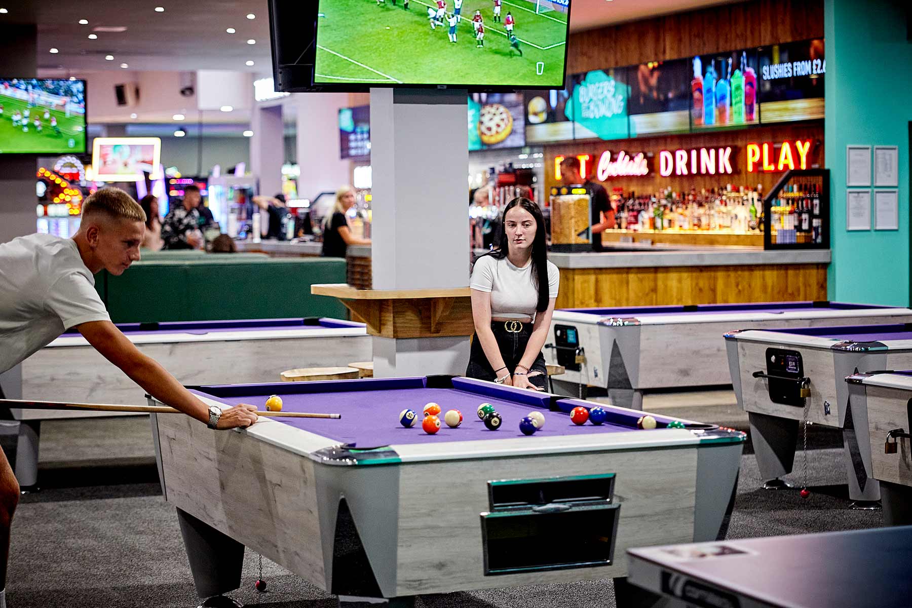 Young Couple Playing Pool In Tenpin Northampton