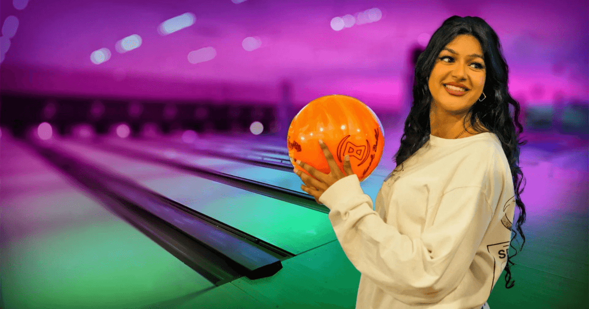 young woman holding bowling ball