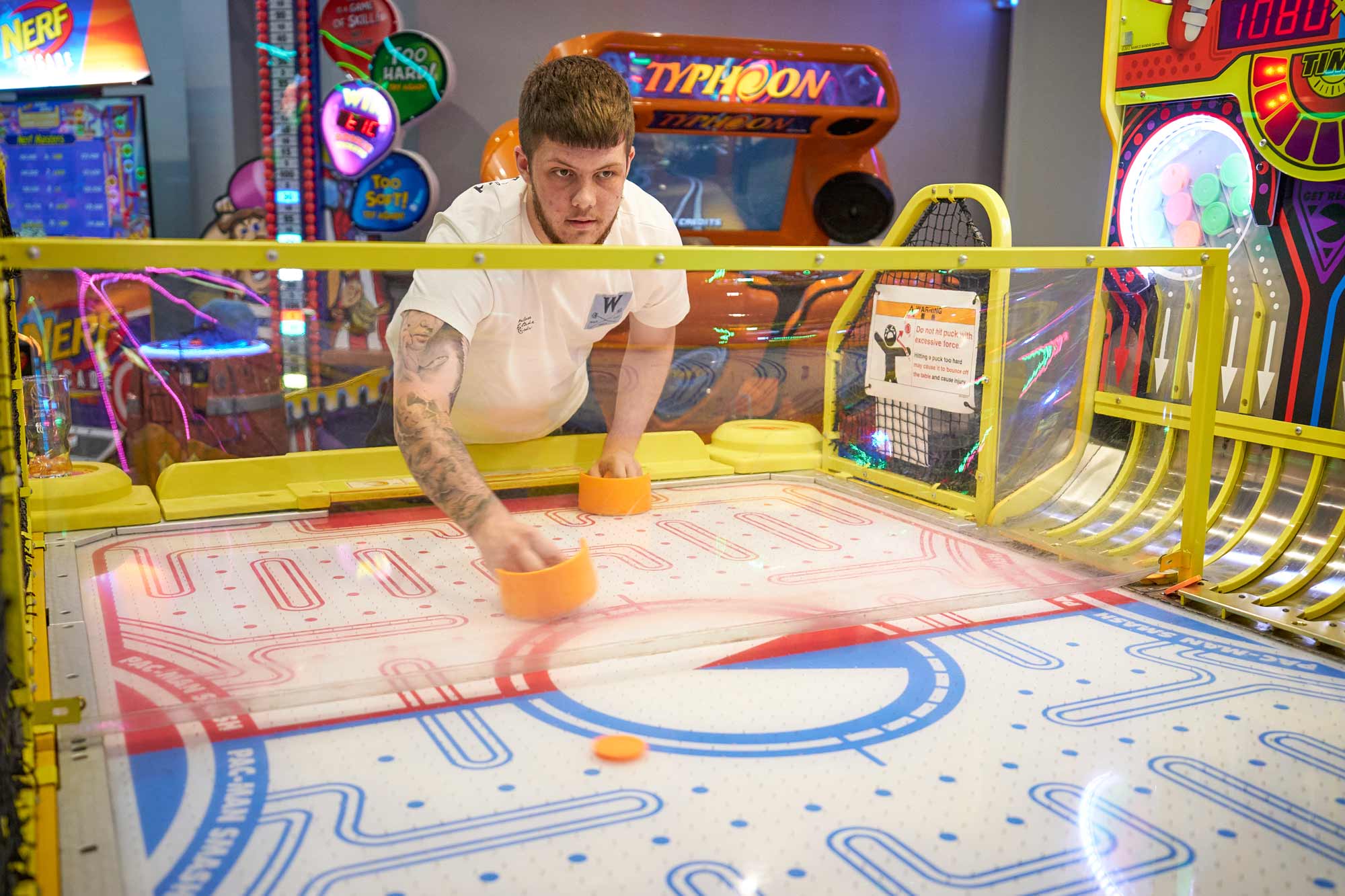 Man Playing Air Hockey At Tenpin Stoke