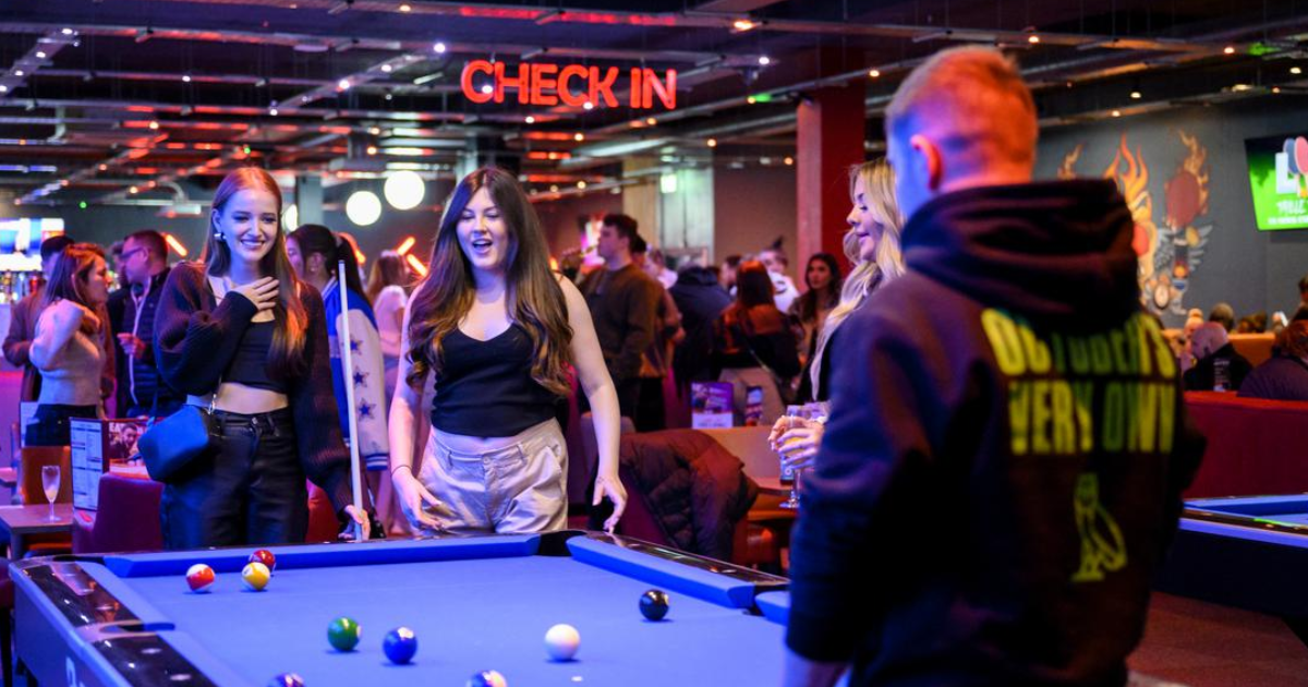 A Group Of Friends Playing Pool