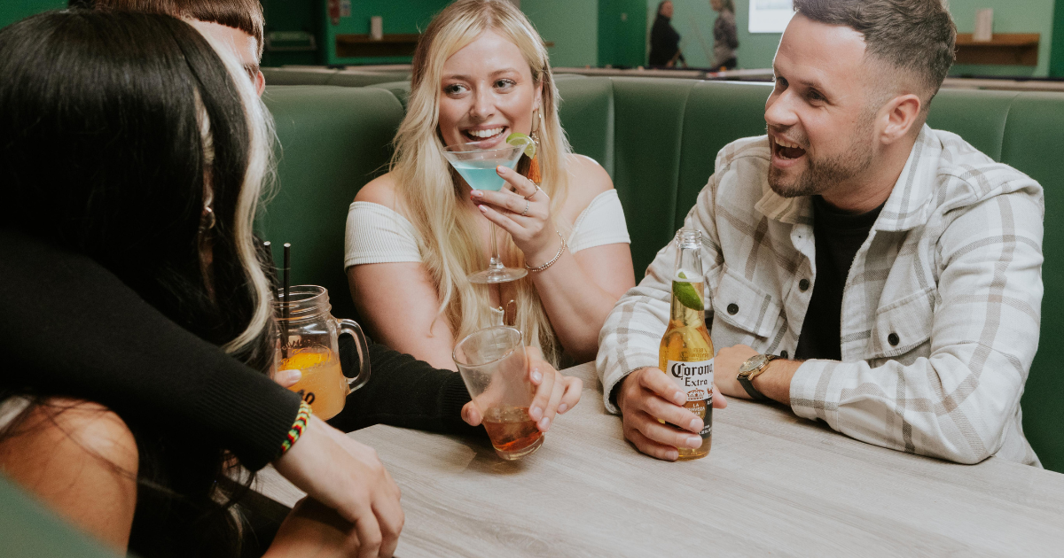 4 Students Enjoying Cocktails And Beers At Tenpin Bar