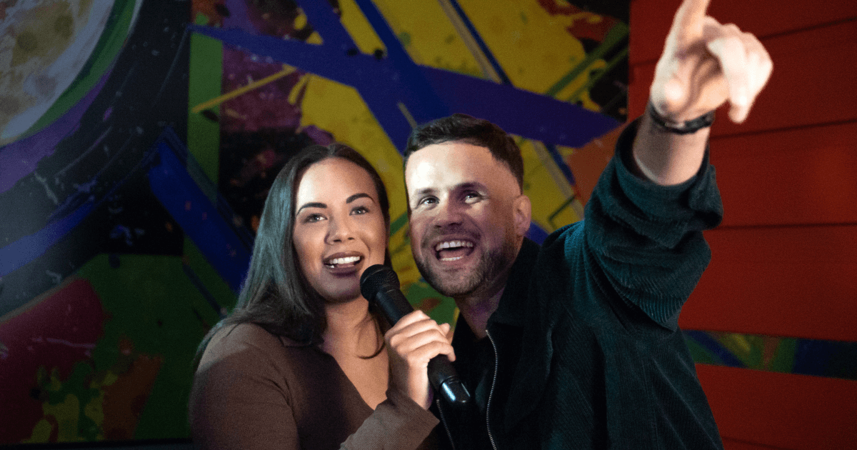 Couple Singing Into Microphone In Karaoke Room (1) (1)