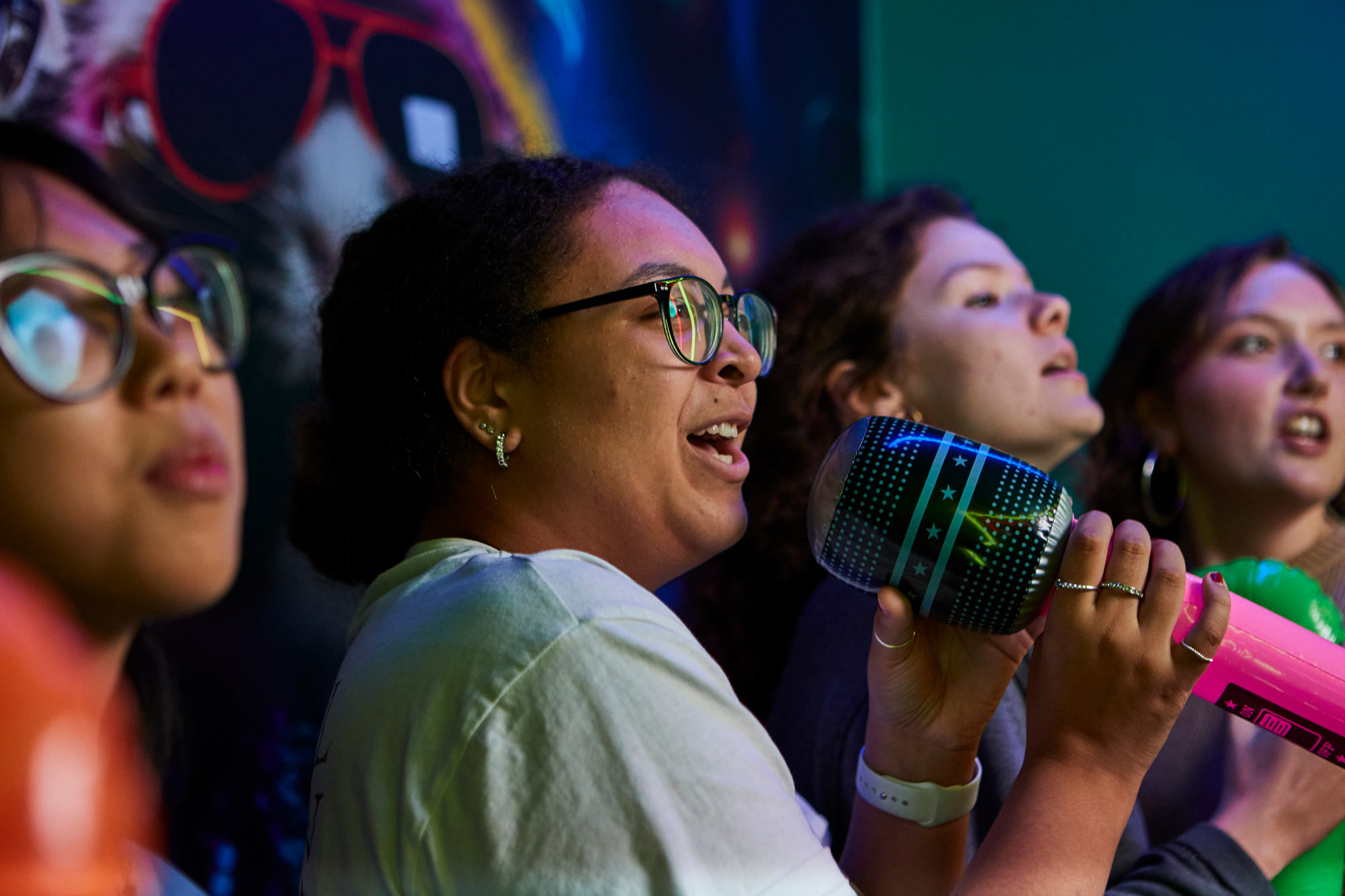 Friends Singing In Karaoke Room