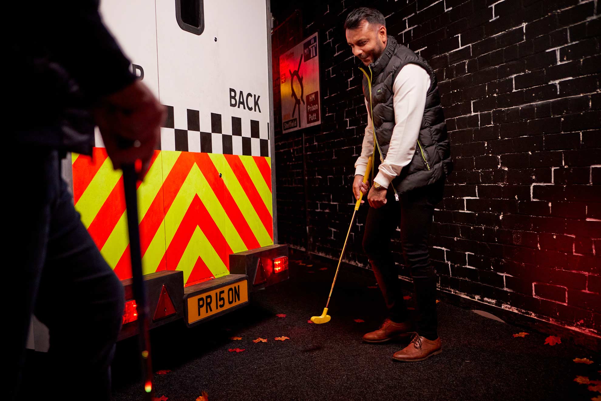 Man Holding Golf Club In Prison Putt Crazy Golf