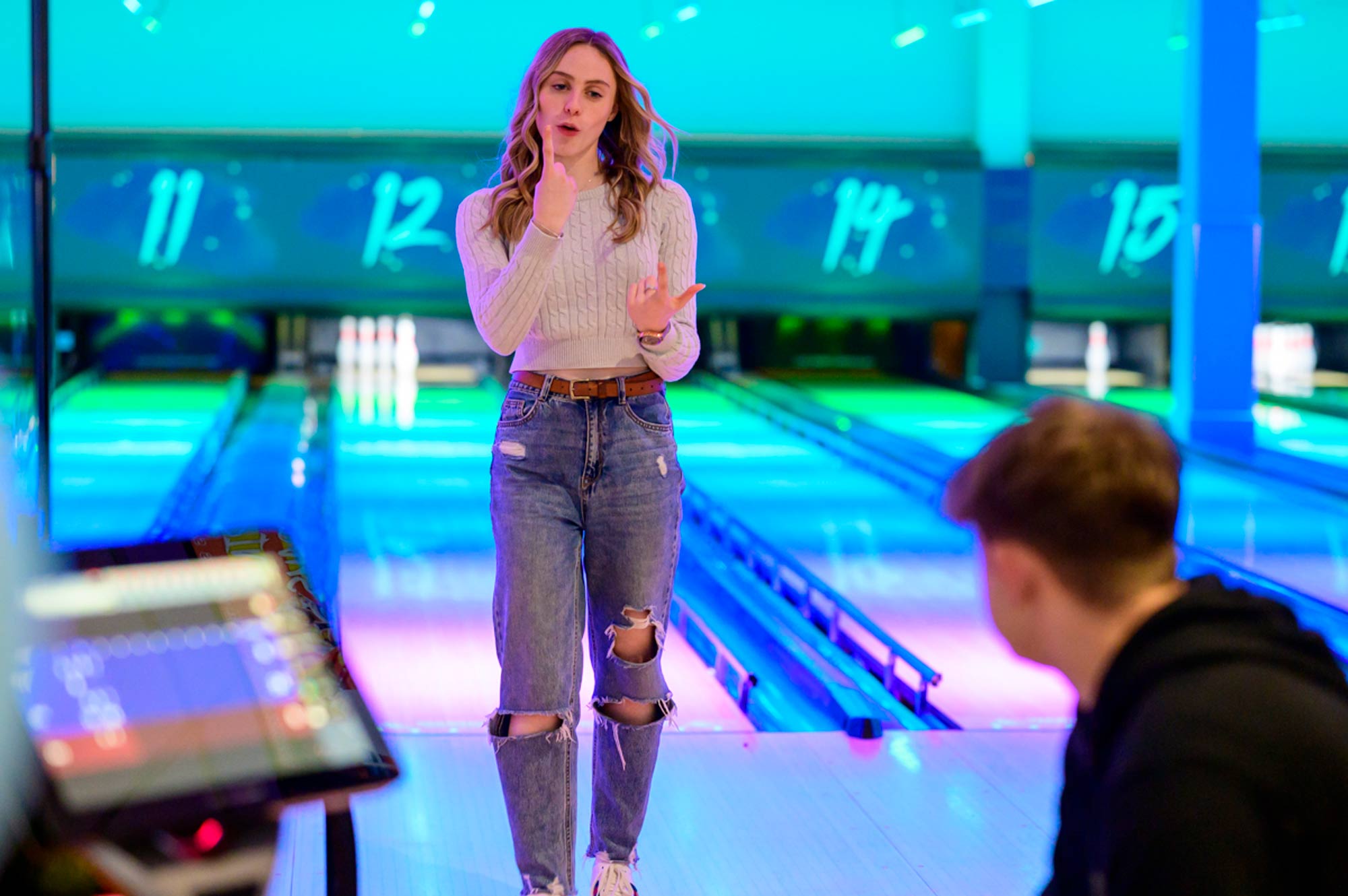 Young woman after taking her bowling shot