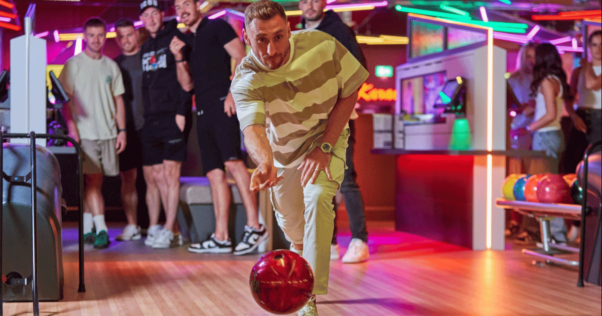 A Group Of Young Men Cheering A Friend Bowling At Tenpin (1)