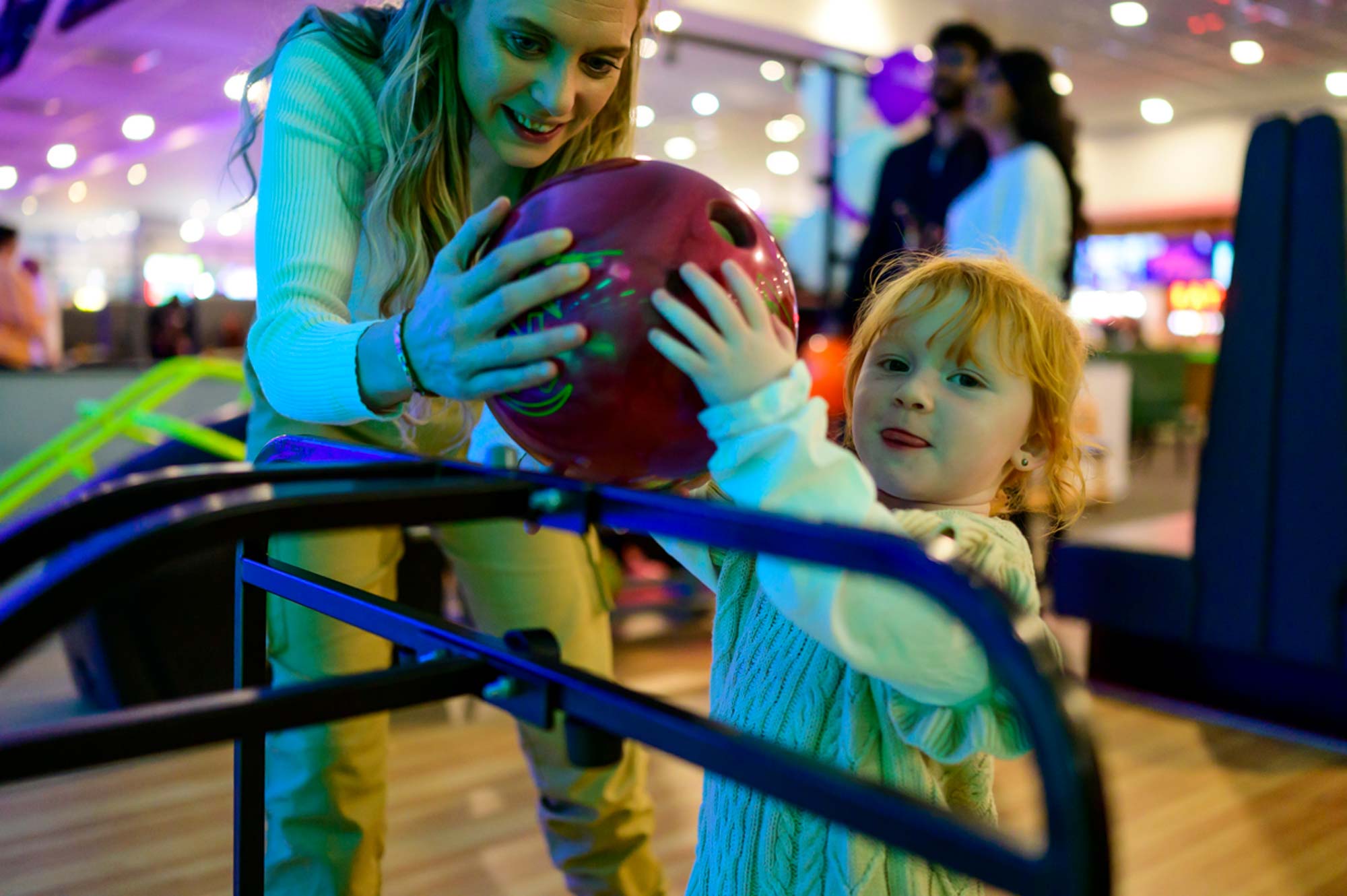 Dudley bowling lanes mum helping toddler with ramp
