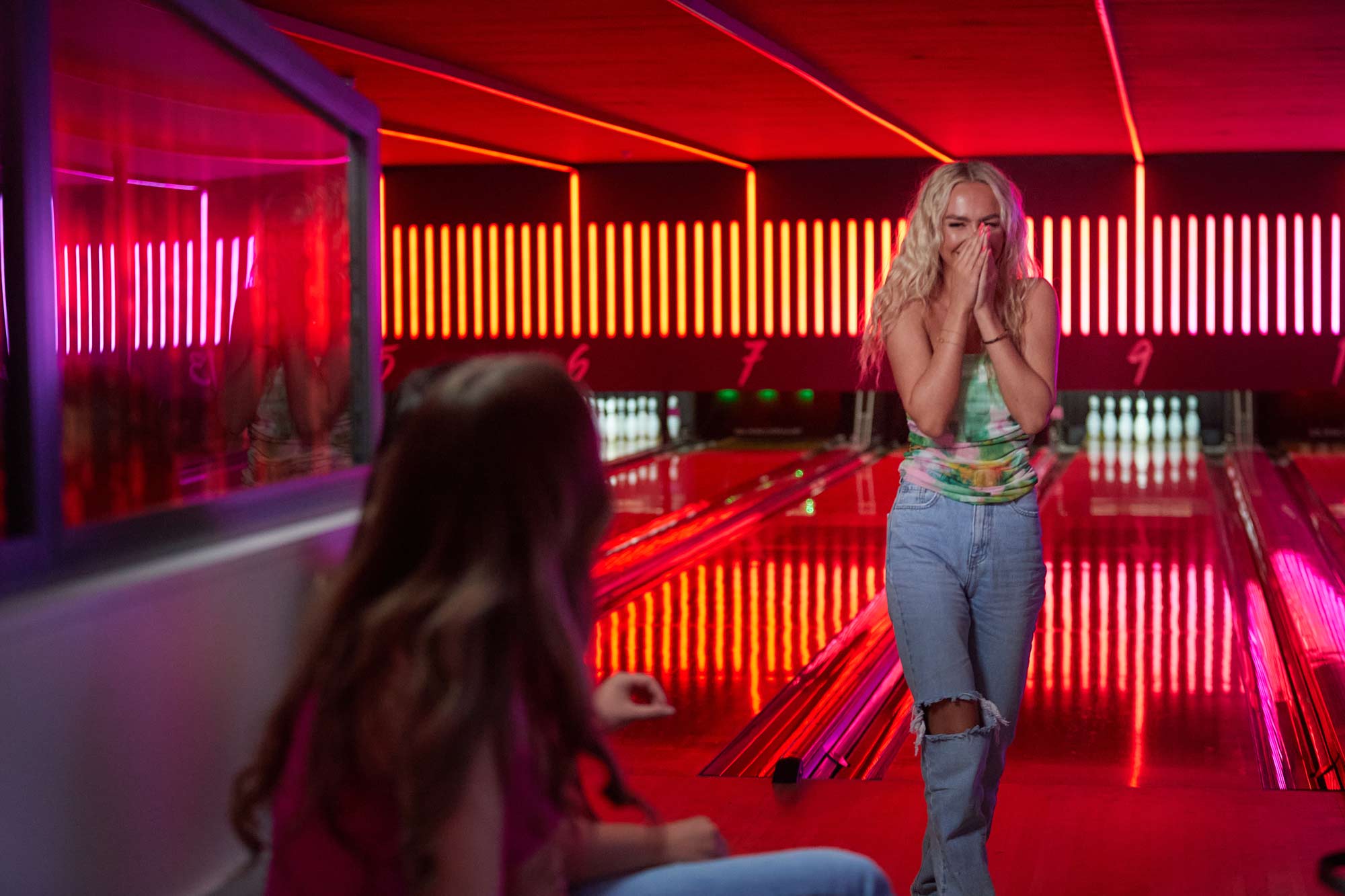 Milton keynes bowling woman giggling with friend