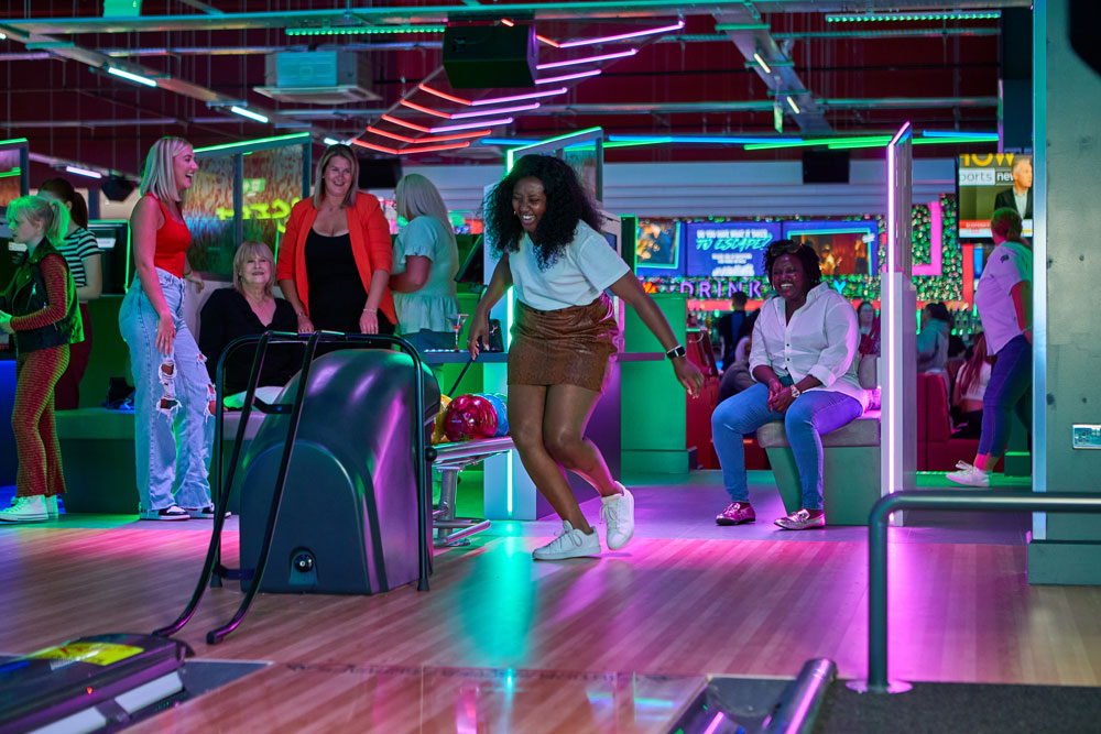 Friends on bowling lanes
