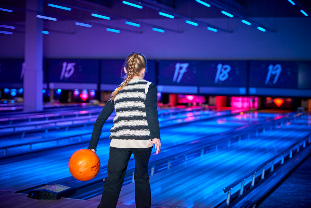 Girl bowling at local bowling alley