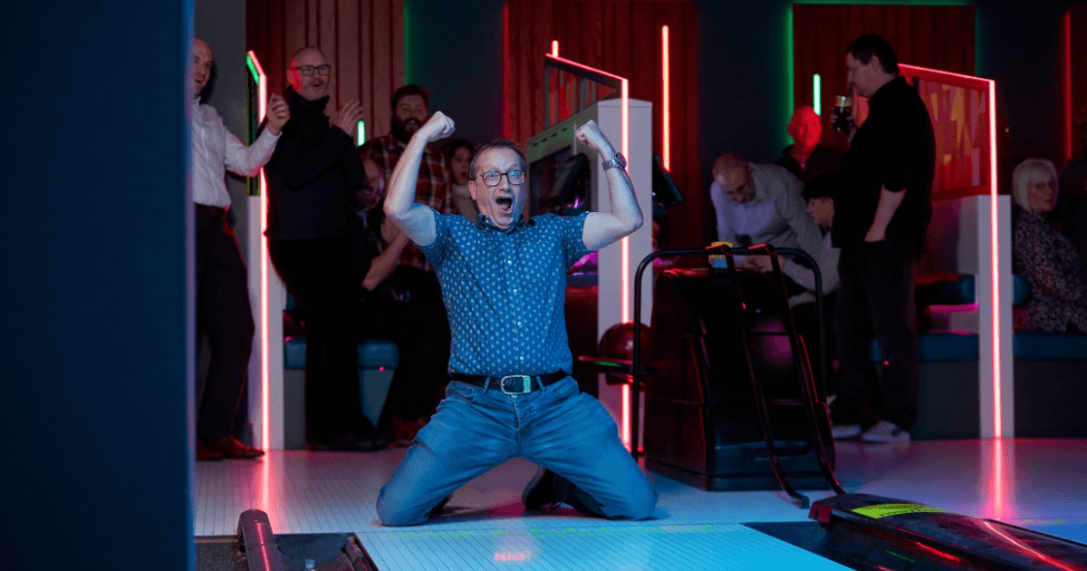 Man Celebrating A Strike At Tenpin Bowling (1)
