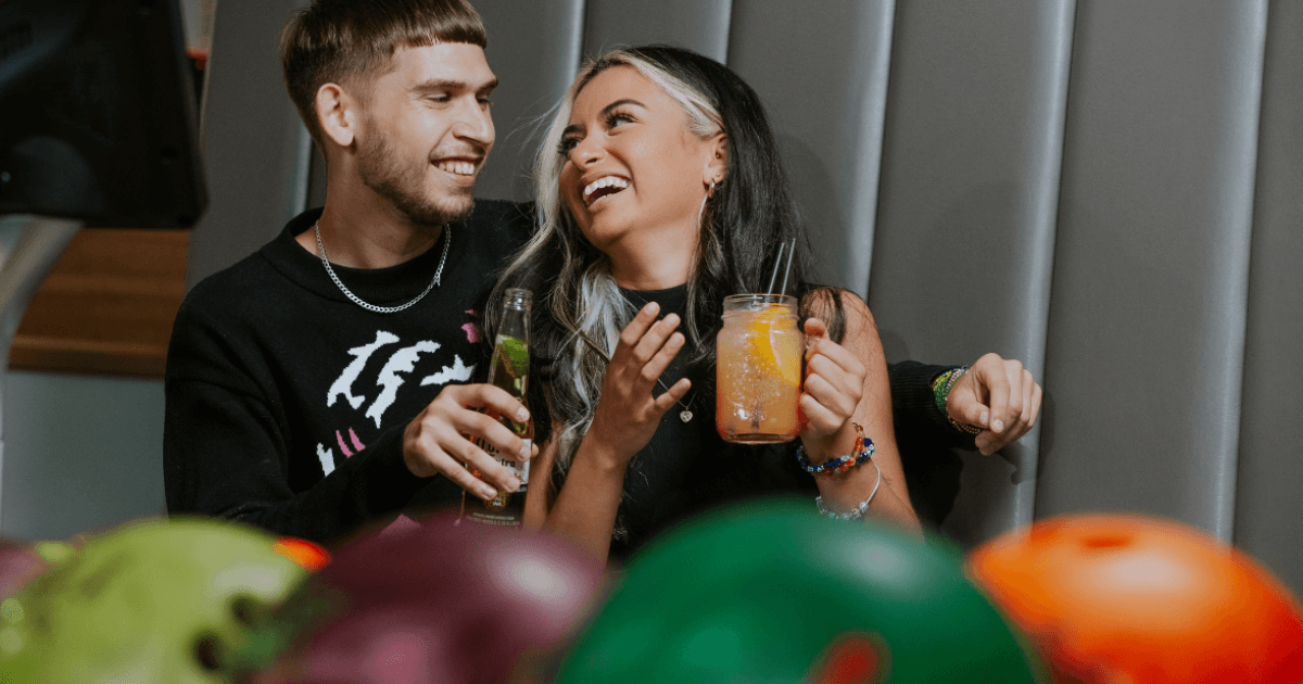 Young Couple Sitting In A Bar Drinking Alcohol (1)