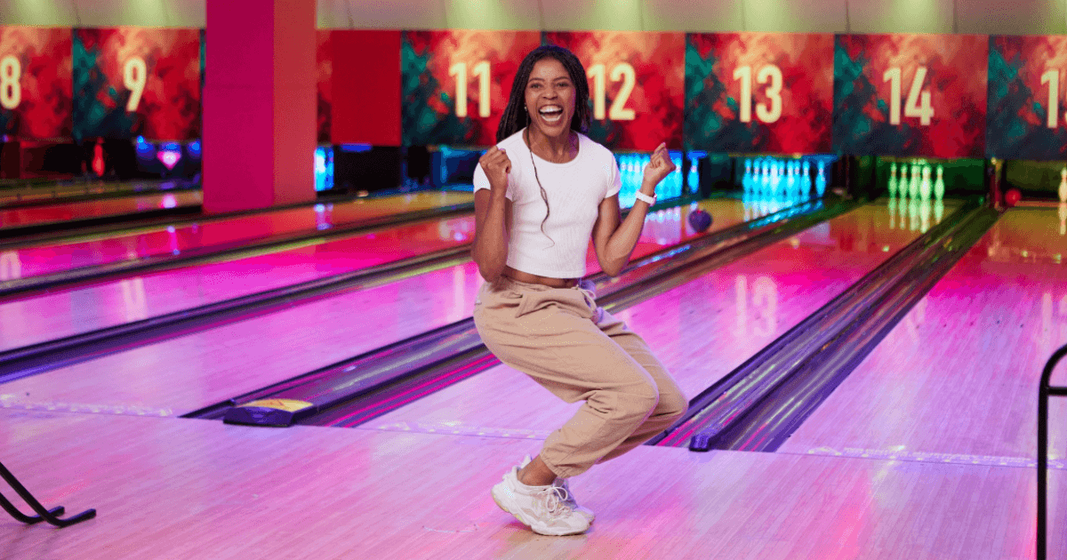 Young Woman Celebrating As She Scores A Strike At Tenpin Bowling (1)