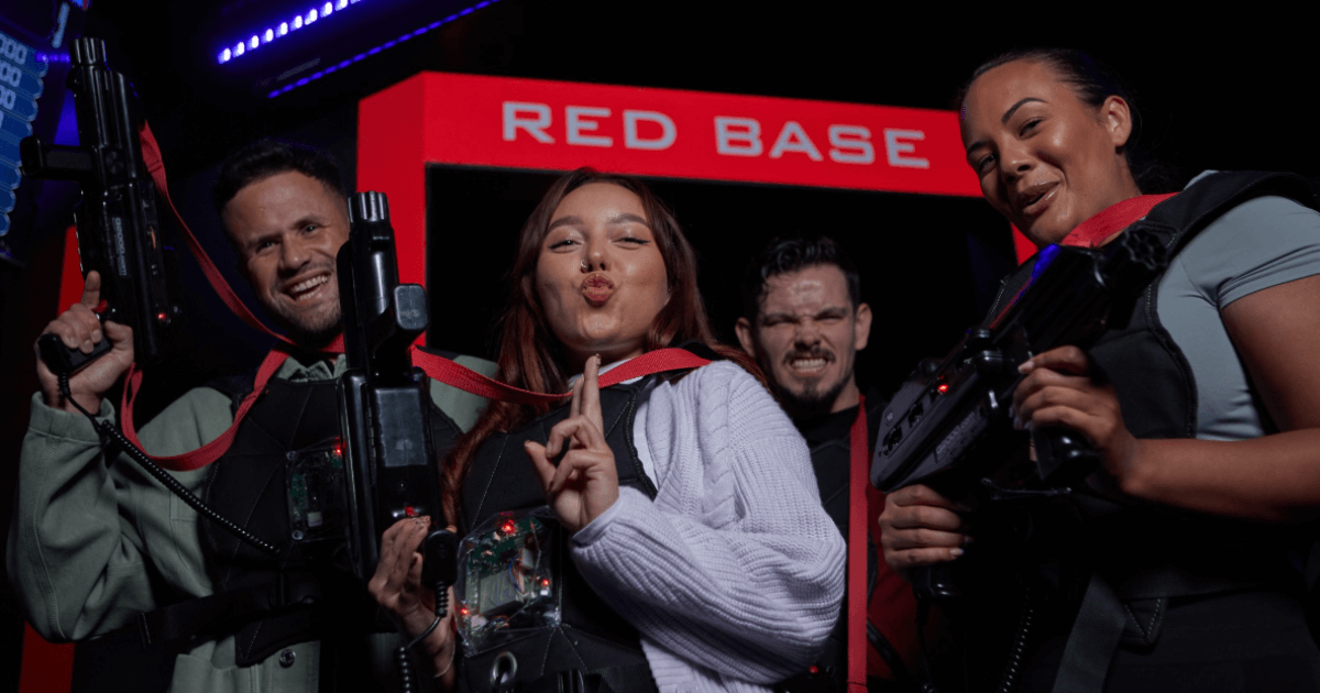 Group Of Young Friends Posing Within Laser Guns At A Laser Zone (1)