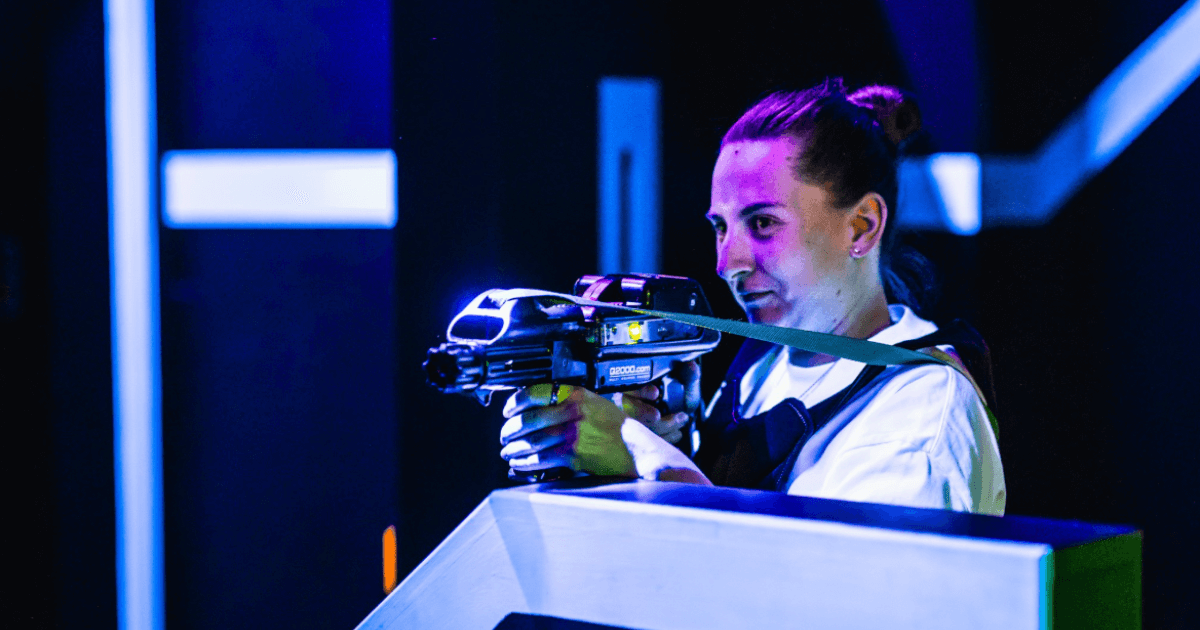 Young Man Point Laser Gun While Hiding Behind Obstacle (1)