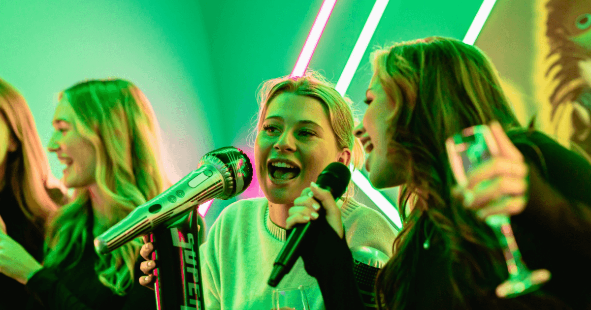 Group Of Friends Singing Karaoke In A Karaoke Booth (1)