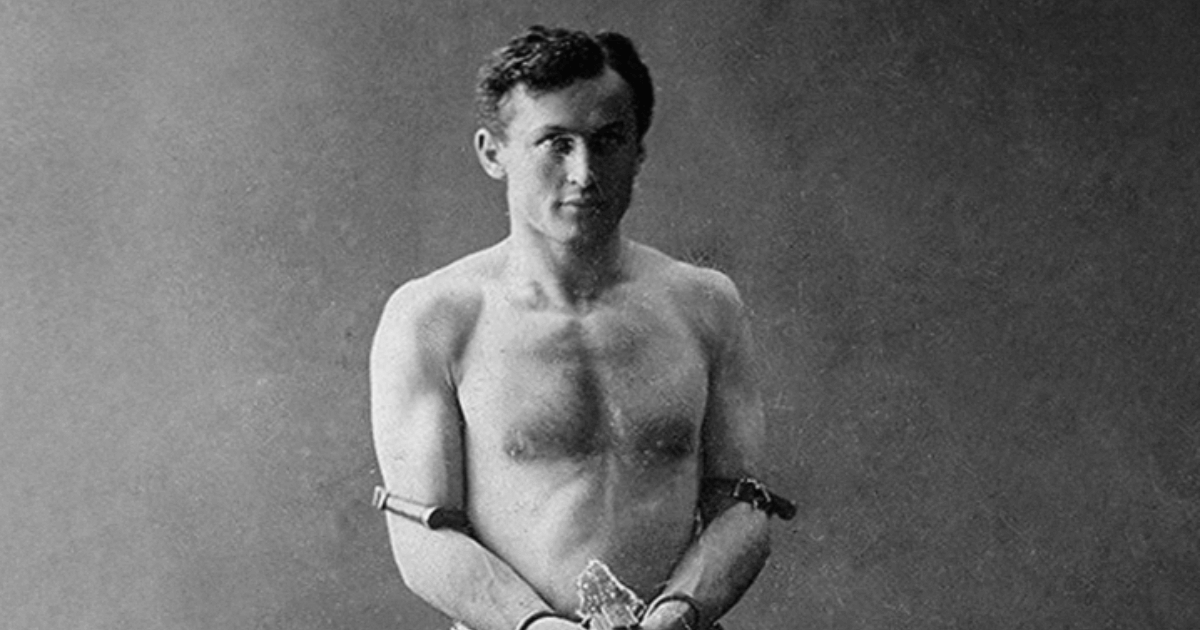 Houdini Standing Without A Top Chained By The Wrists (1)