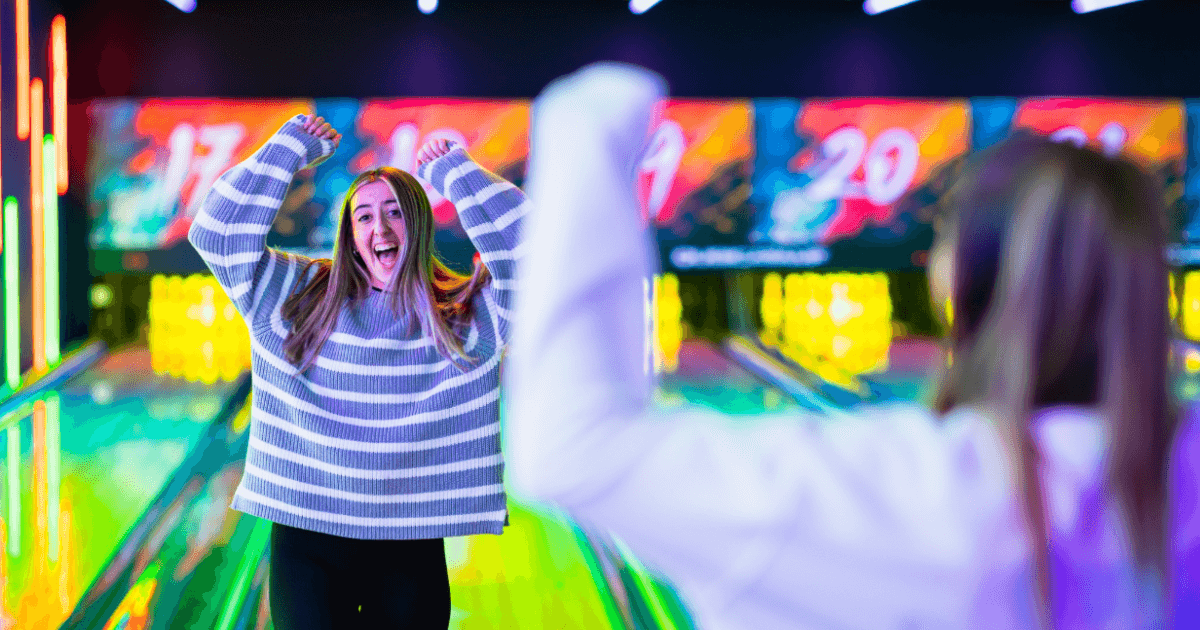 Young Girl Celebrating As She Scores A Strike At Tenpin Bowling (1)