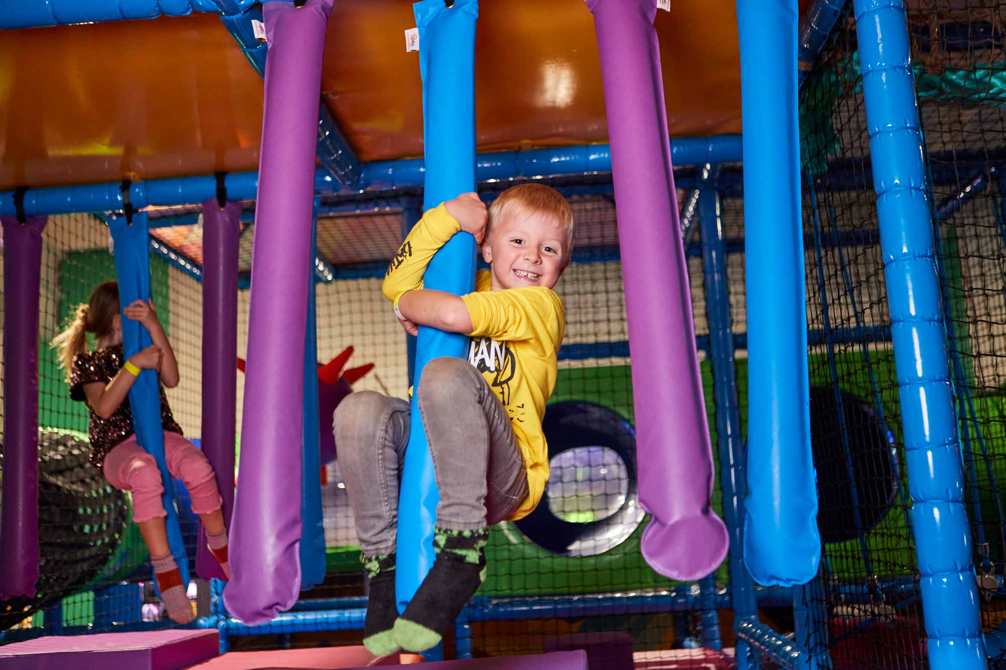 Boy Swinging In Soft Play Area Of A Tenpin Centre