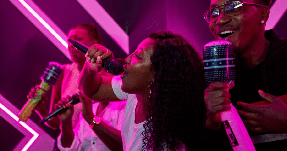 A Group Of Friends Singing Karaoke At Tenpin Inflatable Mics (1)