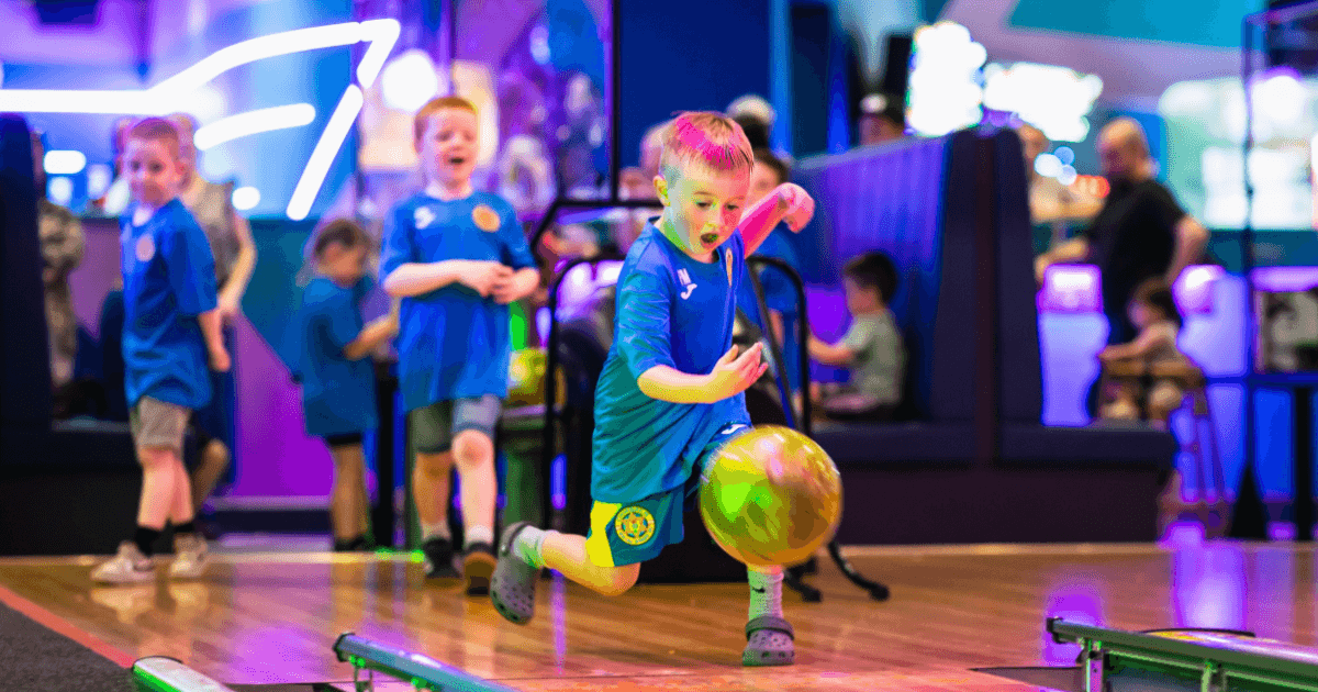 Young Boy Rolling Bowling Ball At Tenpin (1)