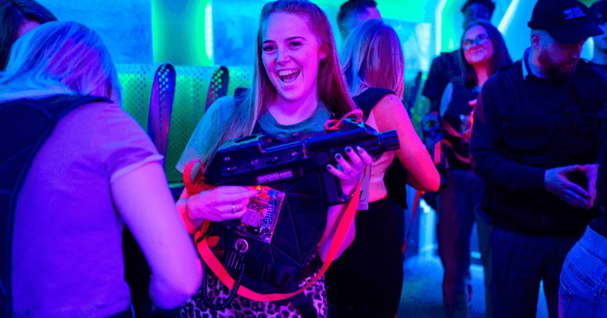 Woman Smiling And Holiding Laser Tag Gun (1)