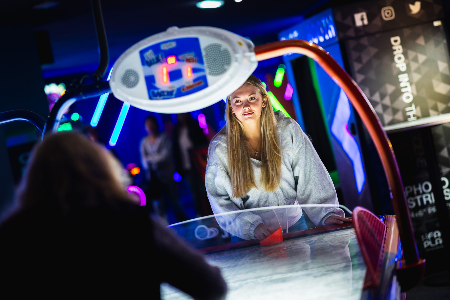 Girl Playing Air Hockey In Tenpin Arcade