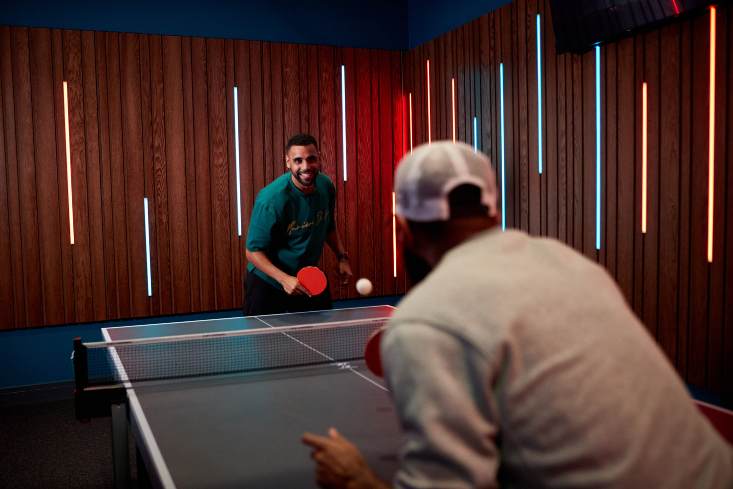 Two Friends Playing Table Tennis At Tenpin